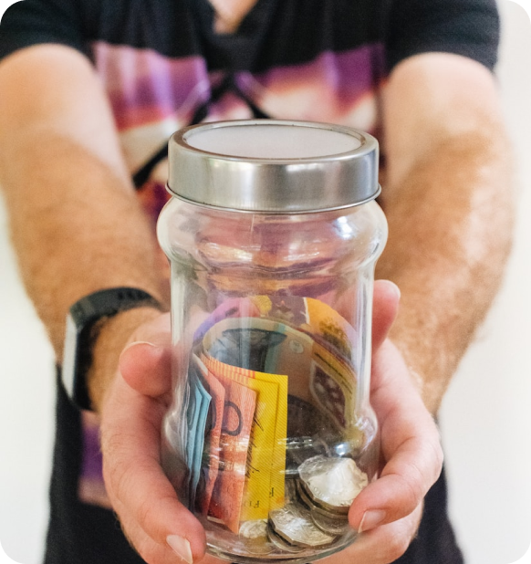 A man holding a jar of money