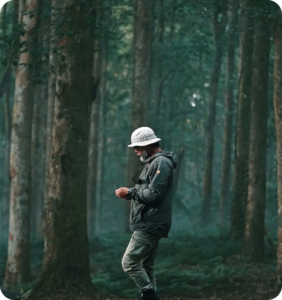 A guy dressed sporty in a forest