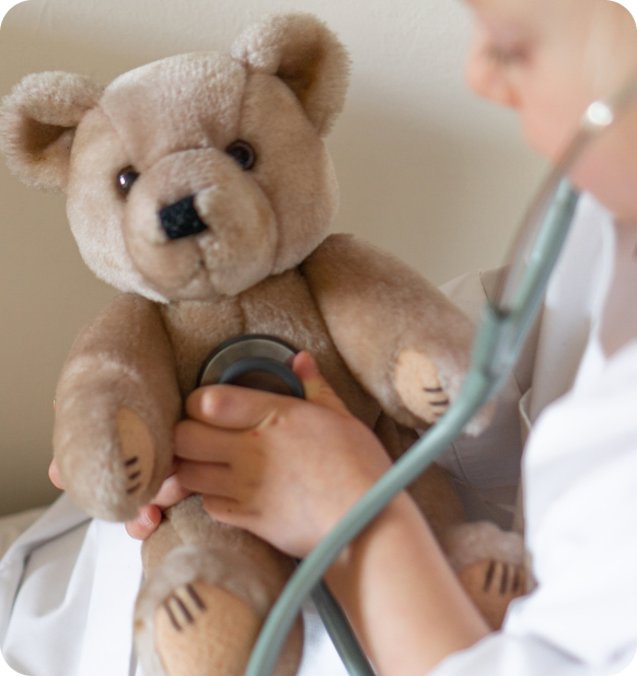 Kids playing doctor with bear