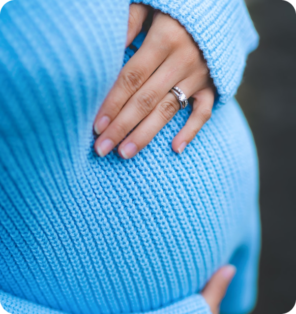 Pregnant women with her ring showing