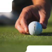 A hand holding a golf ball