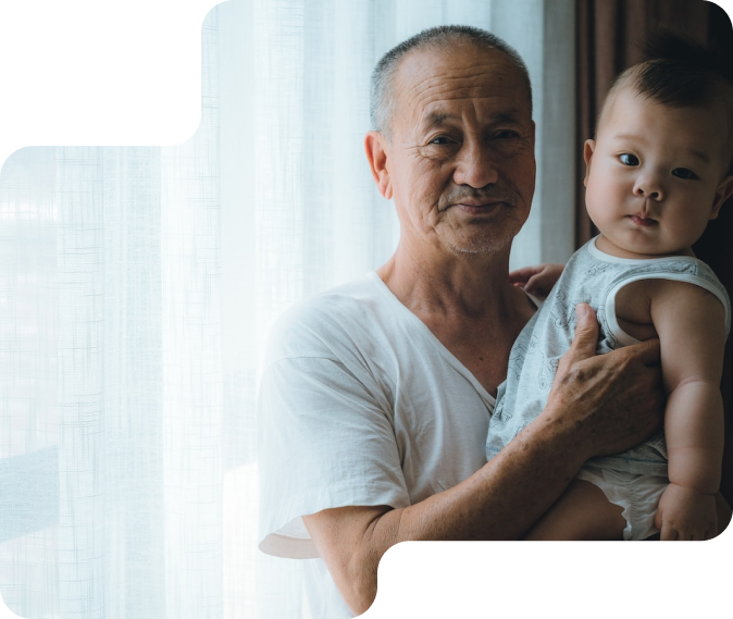 Chinese grandpa holding a baby