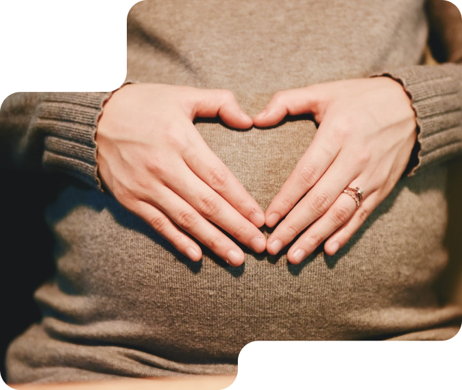 Pregnant woman with heart shape gesture